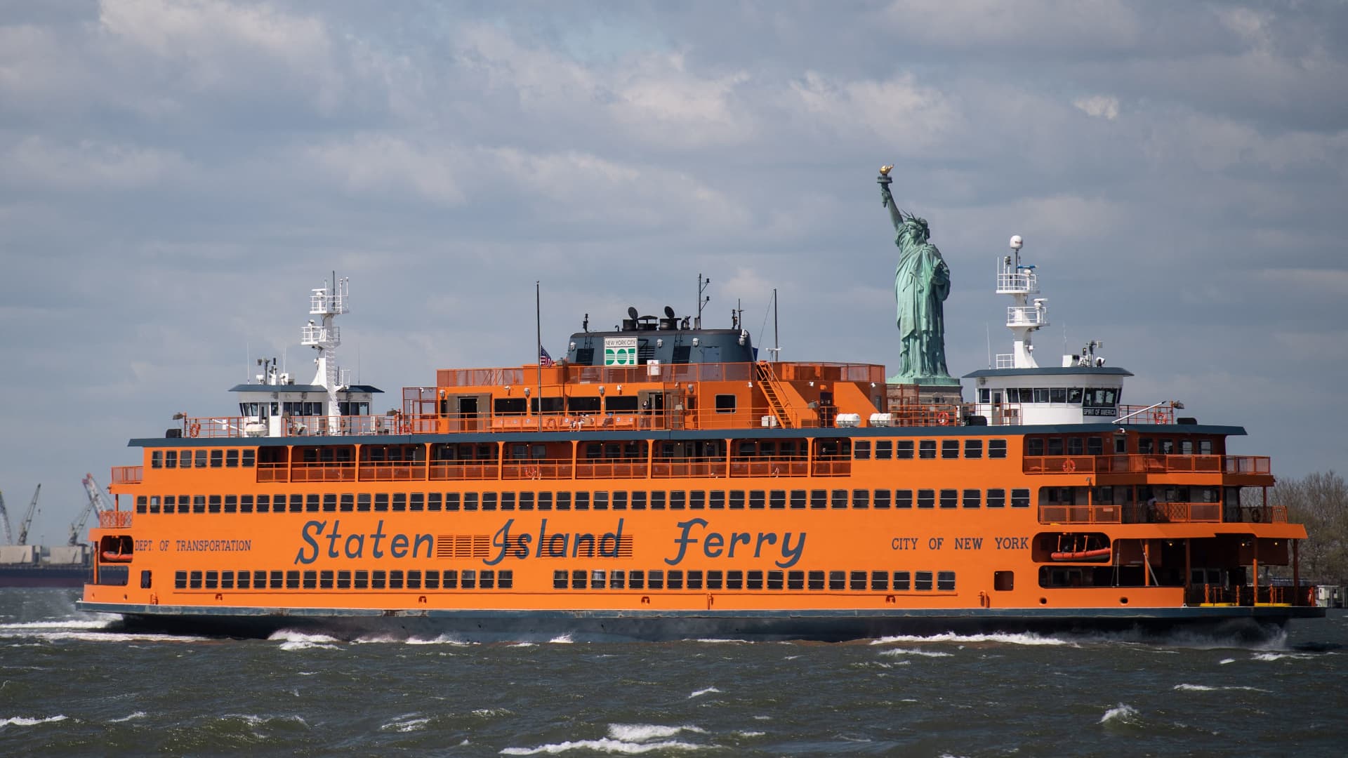 The Staten Island Ferry passes in front of the Statue of Liberty as seen from Governors Island on April 30, 2021 in New York City.