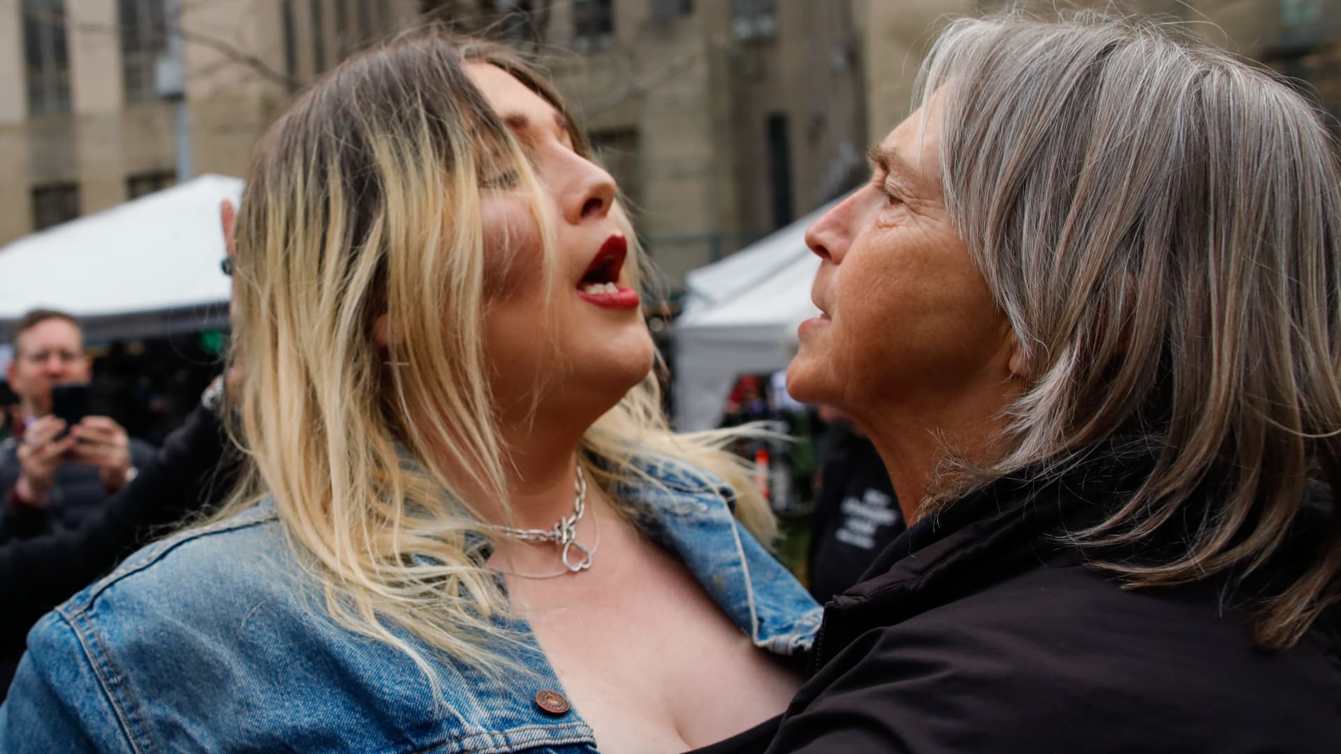 A Trump supporter (L) argues with an Anti-Trump protester after she removed an anti-Trump banner from her outside the Manhattan Criminal Courthouse on April 04, 2023 in New York City. 