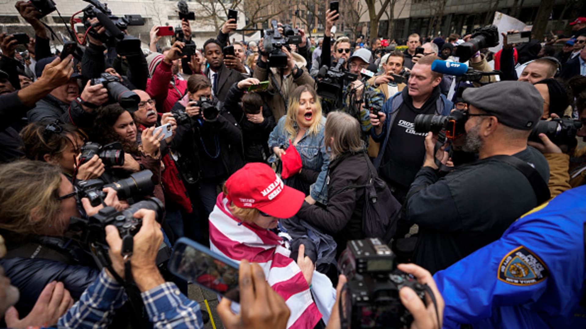 A Trump supporter (L) argues with an Anti-Trump protester after she removed an anti-Trump banner from her outside the Manhattan Criminal Courthouse on April 04, 2023 in New York City. 