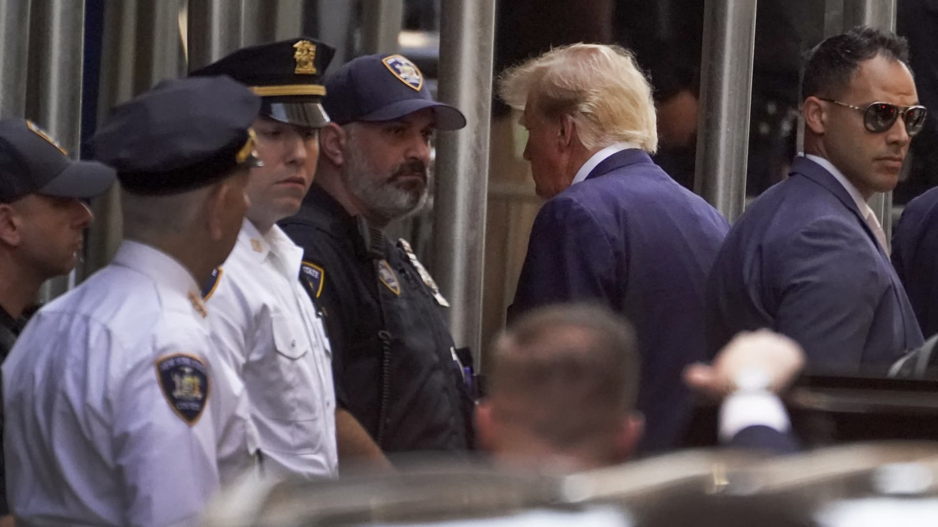 Former President Donald Trump, second from right, arrives at the Manhattan District Attorney's office, Tuesday, April 4, 2023, in New York. Trump is set to appear in a New York City courtroom on charges related to falsifying business records in a hush money investigation, the first president ever to be charged with a crime.