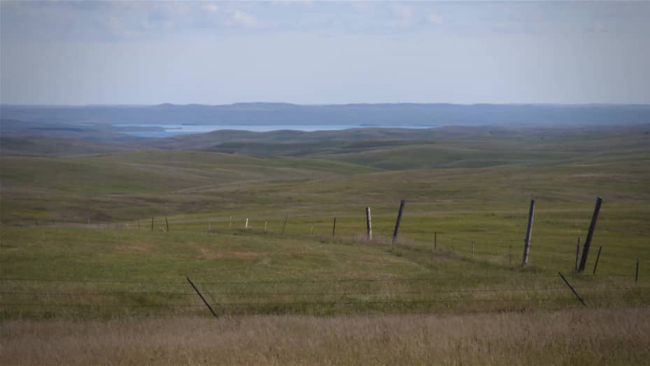 This photo shows the rangeland on the Cheyenne River Reservation with the Missouri River in the distance. The Oceti Sakowin Power Authority wants to build two wind power projects and the Ta'teh Topah project, planned to be 450 megawatts, is the larger of two wind projects. The transmission tie-line for the Ta'teh Topah project will cross the rangeland and the river to interconnect with a Basin Electric transmission line east of the Missouri River. Photo courtesy Oceti Sakowin Power Authority.