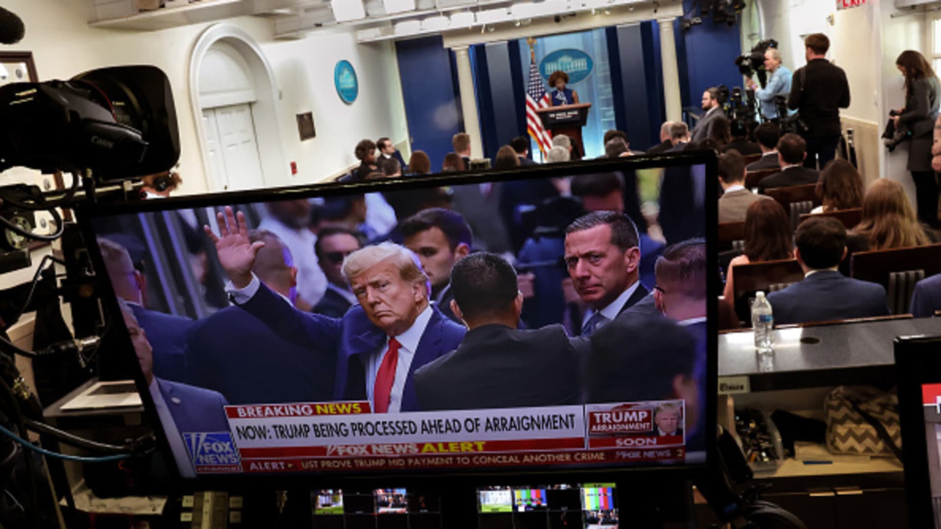 A television screen displays a picture of former President Donald Trump as he is arraigned as White House Press Secretary Karine Jean-Pierre holds a press briefing, at the White House on April 04, 2023 in Washington, DC.