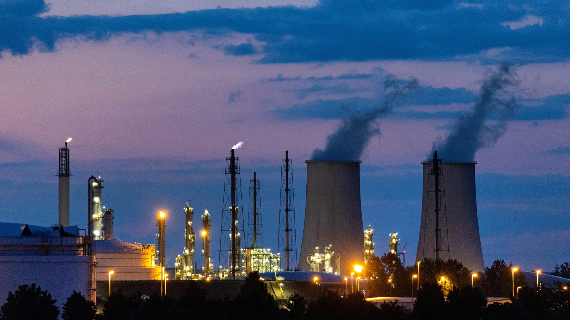 Cooling towers emiting vapor at the Leuna refinery and chemical industrial complex, home to refineries and plants operated by TotalEnergies in Leuna, Germany, on Tuesday, June 7, 2022.