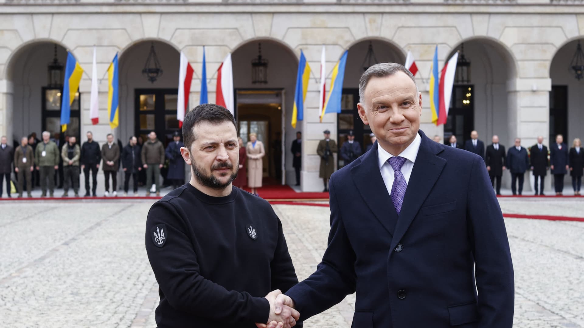 Ukraine's President Volodymyr Zelensky (L) and Polish President Andrzej Duda shake hands during a welcoming ceremony in front of the presidential palace in Warsaw, Poland, on April 5, 2023.
