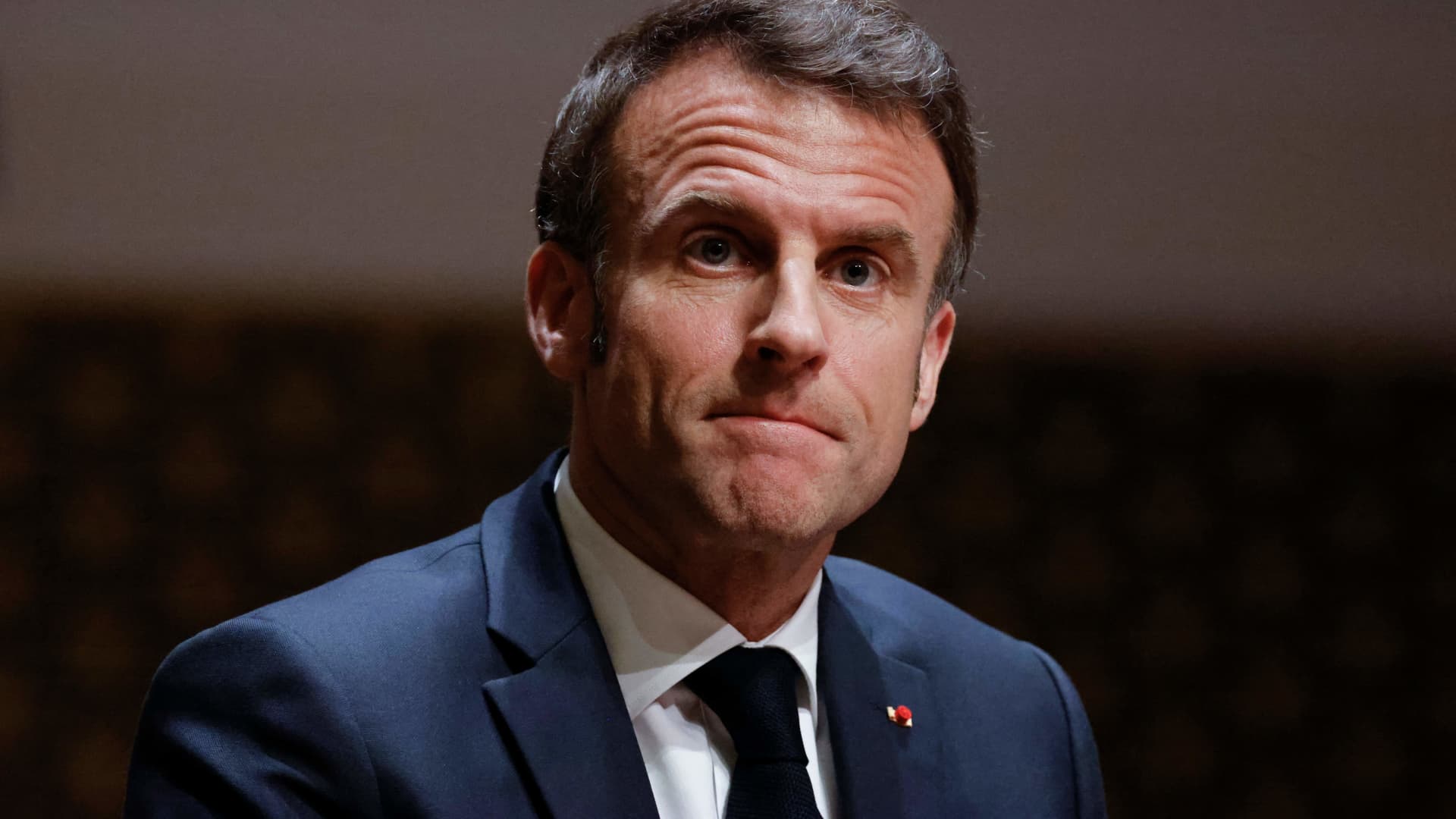 French President Emmanuel Macron looks on after delivering a speech to the Nexus Institute in the Amare theatre in The Hague on April 11, 2023 as part of a state visit to the Netherlands.
