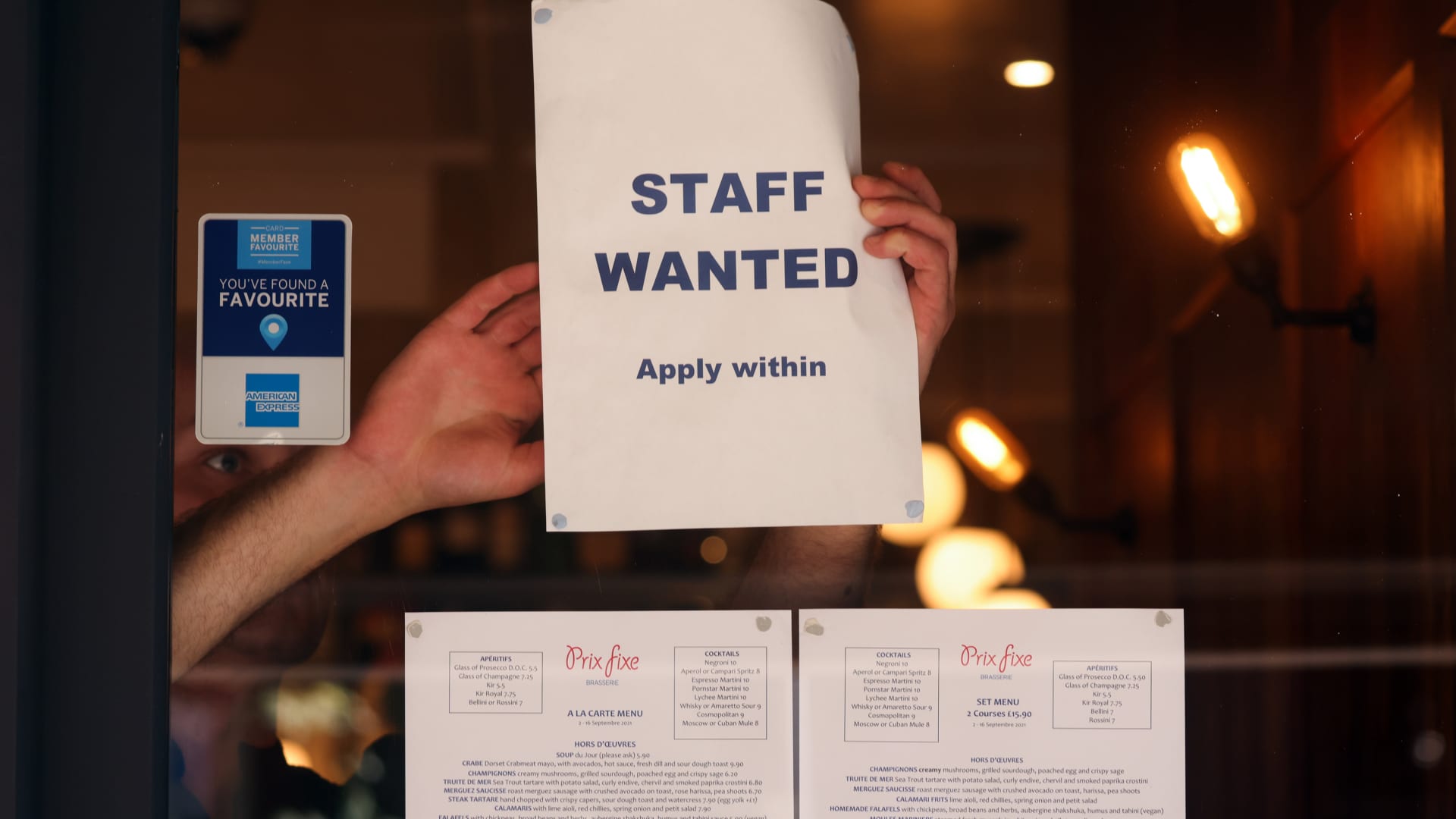 A staff wanted sign in the window of a restaurant in the Soho district of London, U.K., on Tuesday, Sept. 7, 2021.