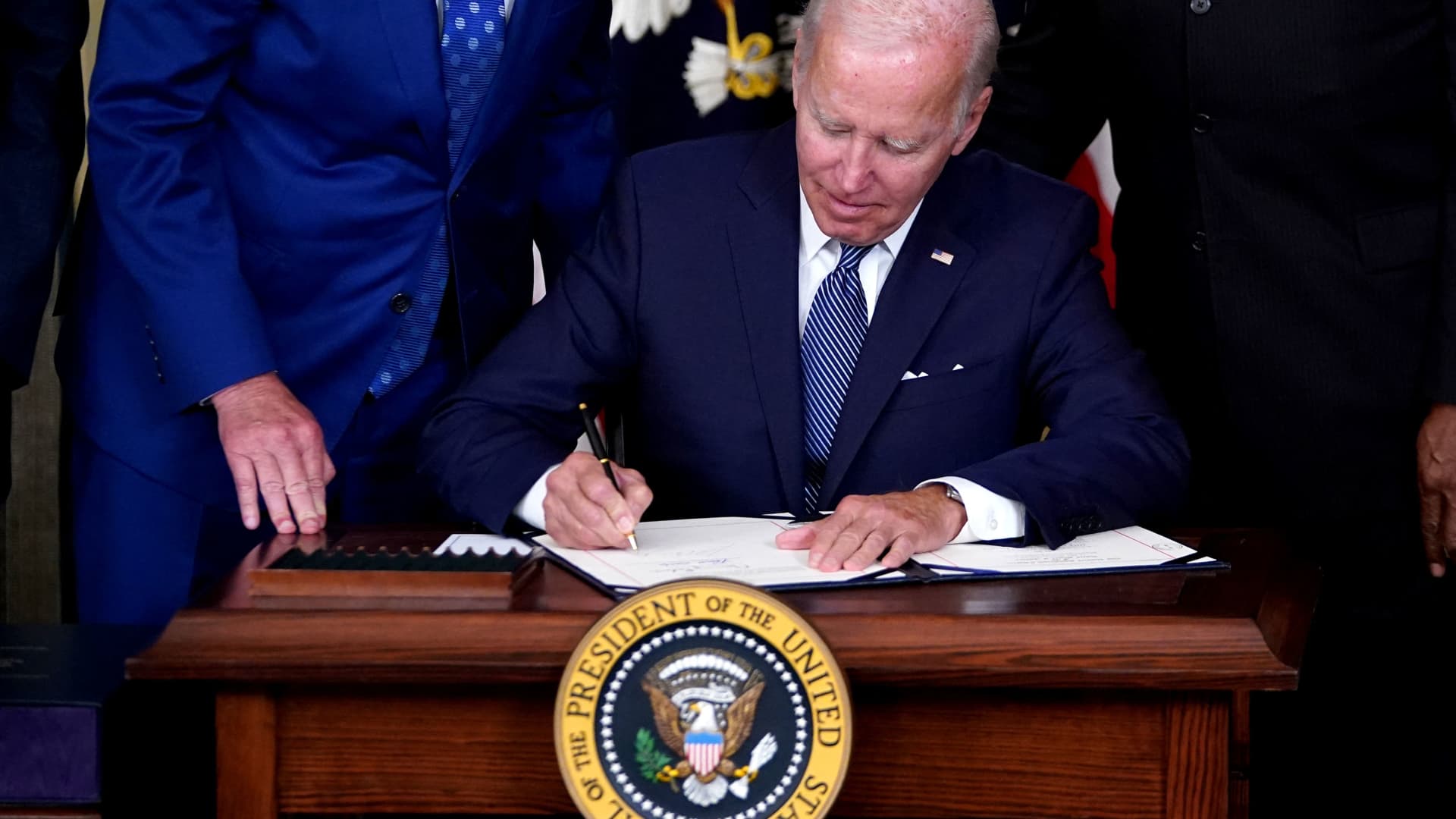 President Joe Biden signs the Inflation Reduction Act of 2022 at the White House on Aug. 16, 2022.