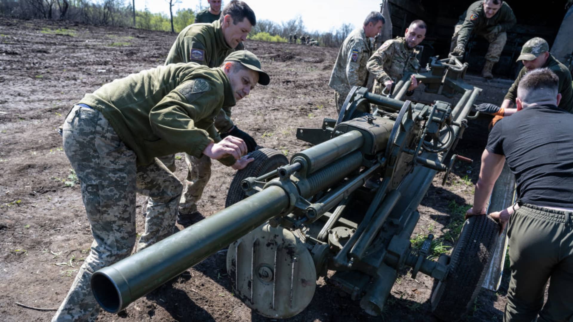 Ukrainian soldiers pull a Soviet-made 82mm gun-mortar in a truck, as Ukrainian Armed Forces units train for a critical and imminent spring counteroffensive against Russian troops, which invaded 14 months earlier, in the Donbas region, Ukraine, on April 26, 2023. 