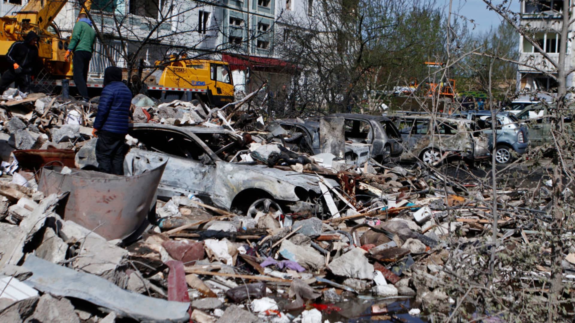 A man stands amid rubble near burnt car on April 28, 2023 in Uman, Ukraine. Overnight, Russia carried out a massive missile attack on the entire territory of Ukraine. A rocket hit a residential building in Uman. Rescuers are conducting a search and rescue operation. (Photo by Yan Dobronosov/Global Images Ukraine via Getty Images)