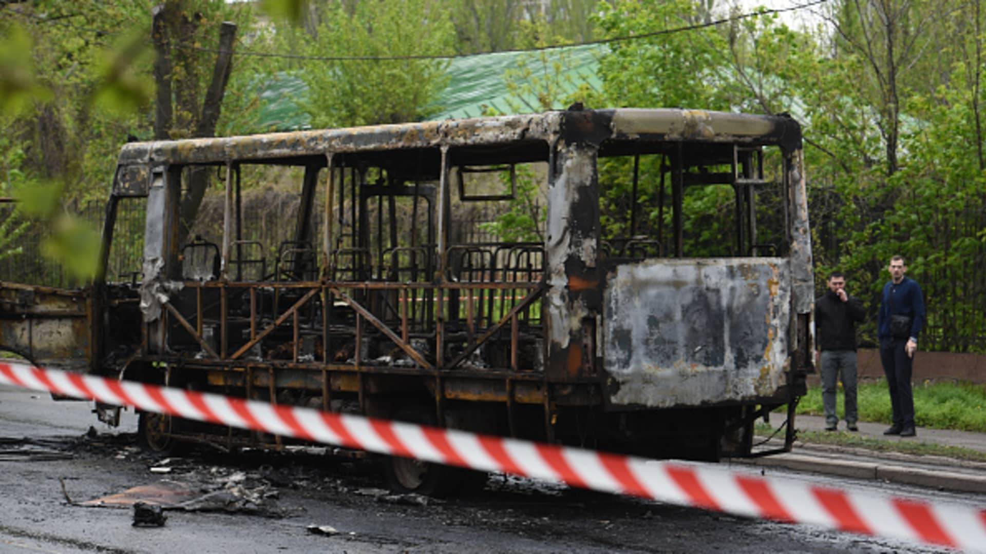 A view of the burnt bus as soldiers inspect the site after a shelling by Ukraine's Armed Forces in Donetsk, Russian-controlled territory, Ukraine on April 28, 2023. A missile hit a bus with civilians in the center of Donetsk, leaving seven people dead and eight others injured. 