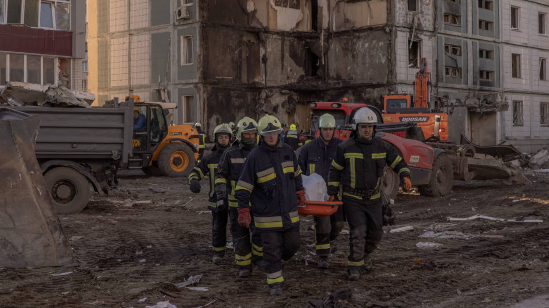 Emergency workers carry on a stretcher a body of a victim found under the rubble of the destroyed residential building following the Russian attack, on April 28, 2023 in Uman, Ukraine.