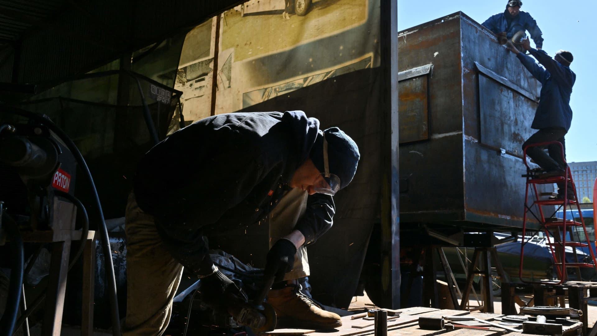 Workers build an armoured vehicle for medical use at a workshop in Kyiv's outskirts on May 1, 2023. 