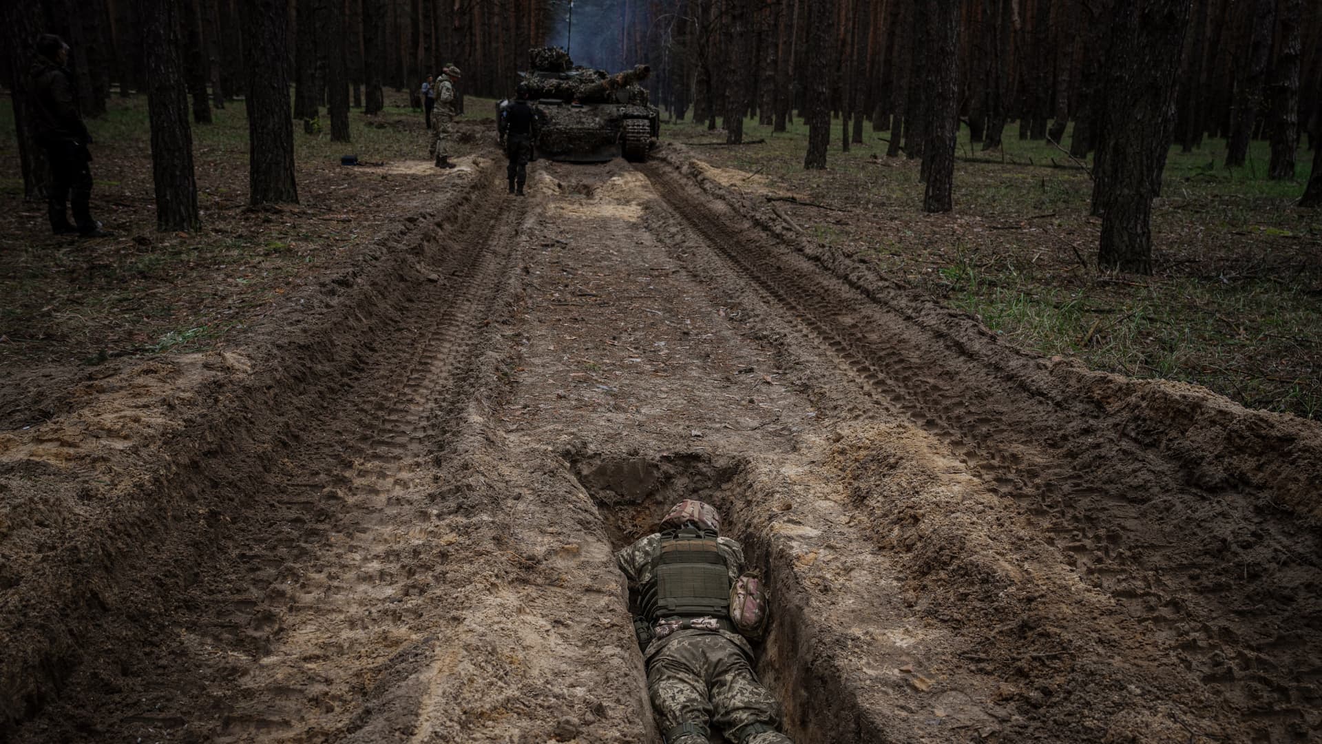 A Ukrainian serviceman lies in a trench during a military exercise in the Kharkiv region on May 1, 2023, amid the Russian invasion of Ukraine. 