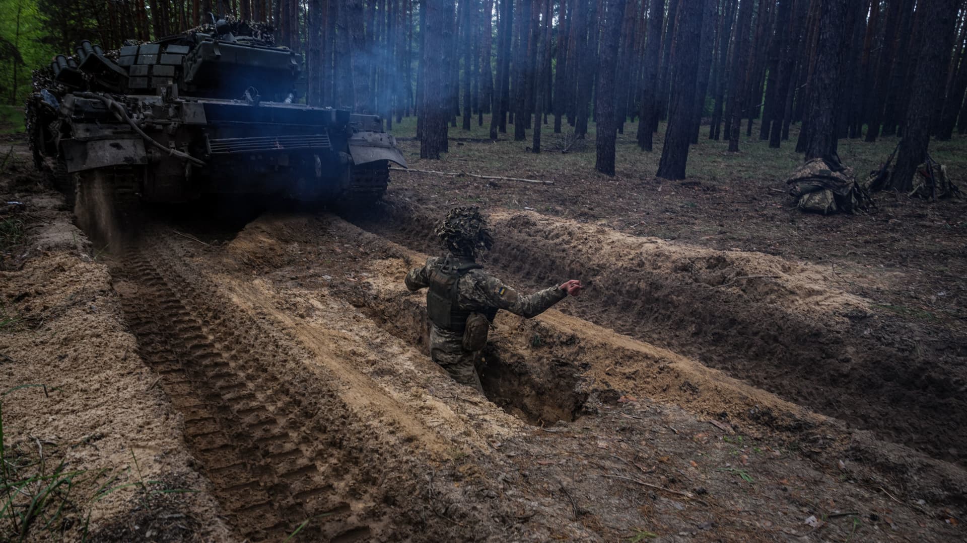 A Ukrainian serviceman stands up in a trench after a drill during a military exercise in the Kharkiv region on May 1, 2023, amid the Russian invasion of Ukraine. 