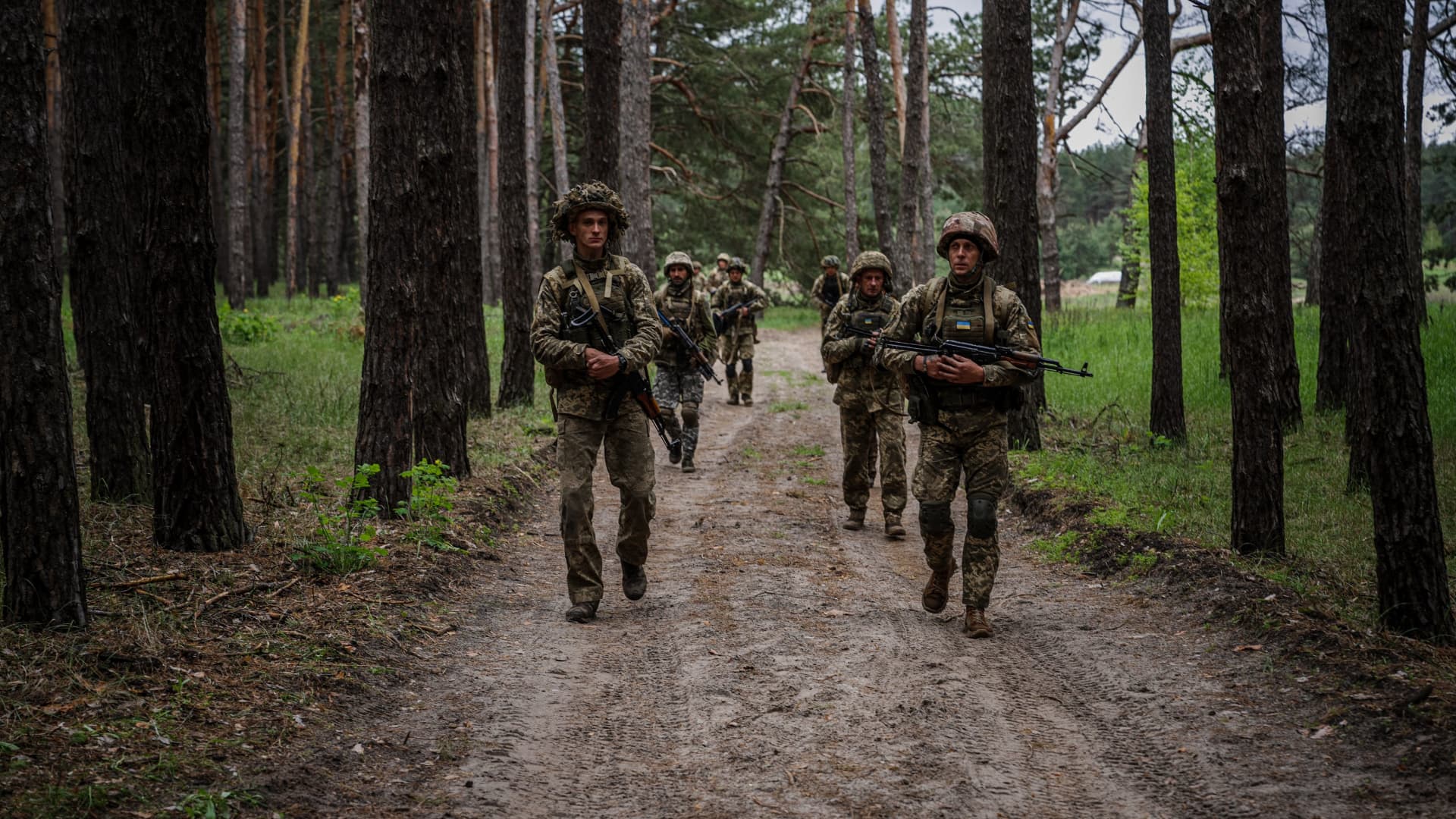 Ukrainian servicemen walk through a forest during a military exercise in the Kharkiv region on May 1, 2023, amid the Russian invasion of Ukraine. 