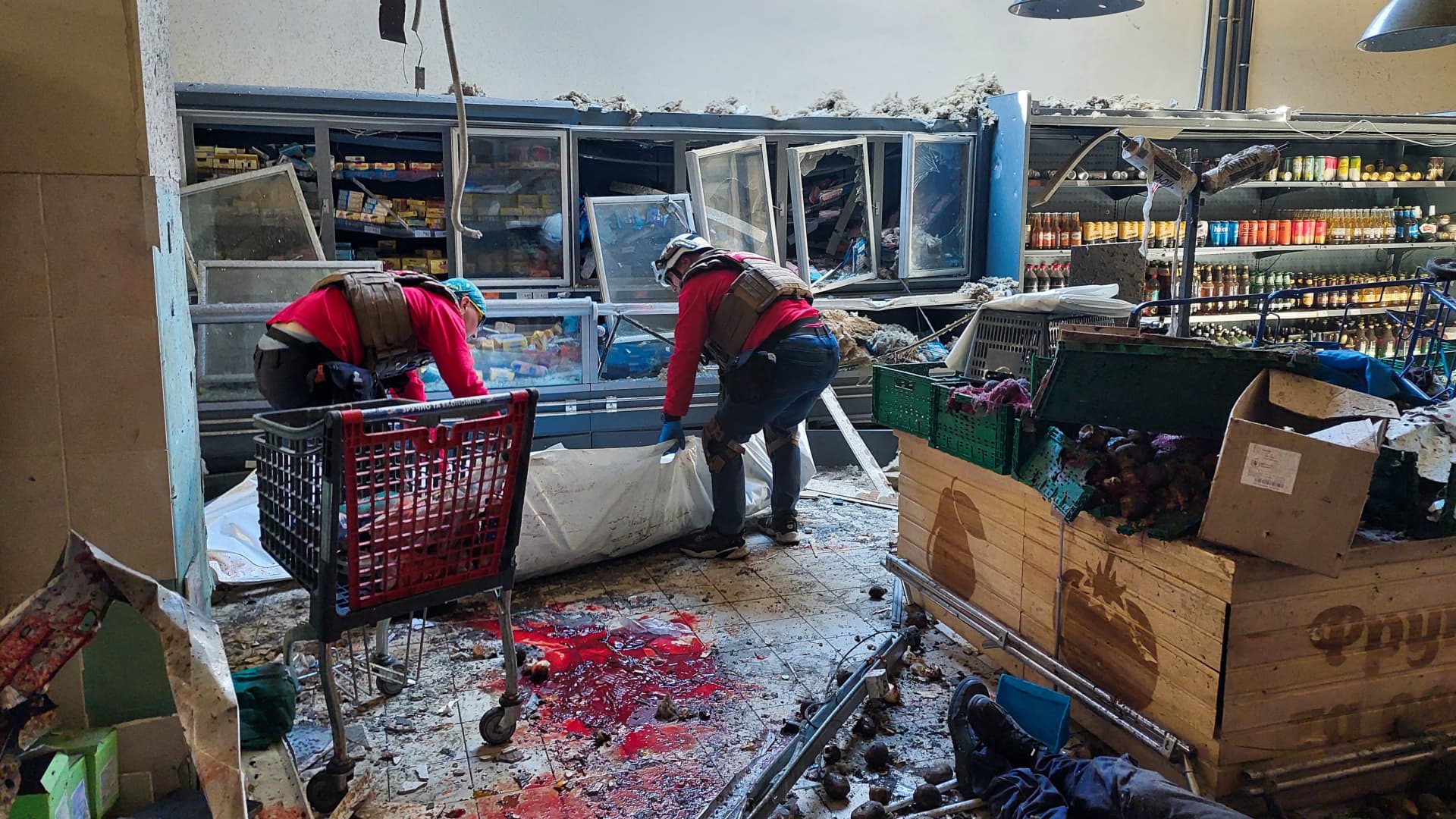 EDITORS NOTE: Graphic content / Paramedics collect bodies of local residents, killed in a local supermarket following Russian strike in the southern Ukrainian town of Kherson on May 3, 2023, amid the Russian invasion of Ukraine.