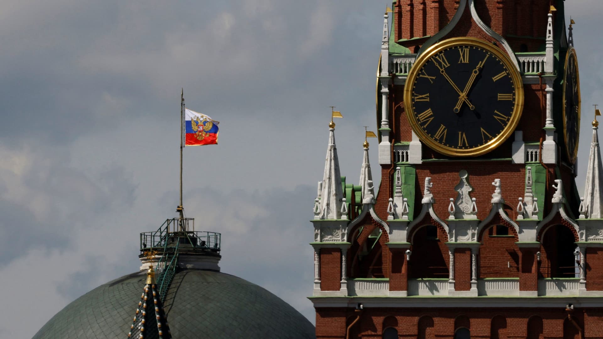 The Russian flag flies on the dome of the Kremlin Senate building behind Spasskaya Tower, while the roof shows what appears to be marks from the recent drone incident, in central Moscow, Russia, May 4, 2023. 