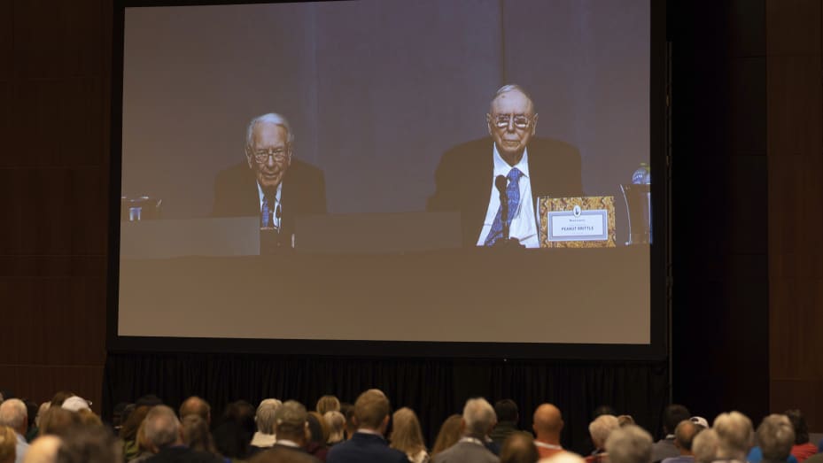 Shareholders watch Warren Buffett and Charlie Munger from the overflow room during the Berkshire Hathaway annual meeting on Saturday, May 6, 2023, in Omaha, Neb.