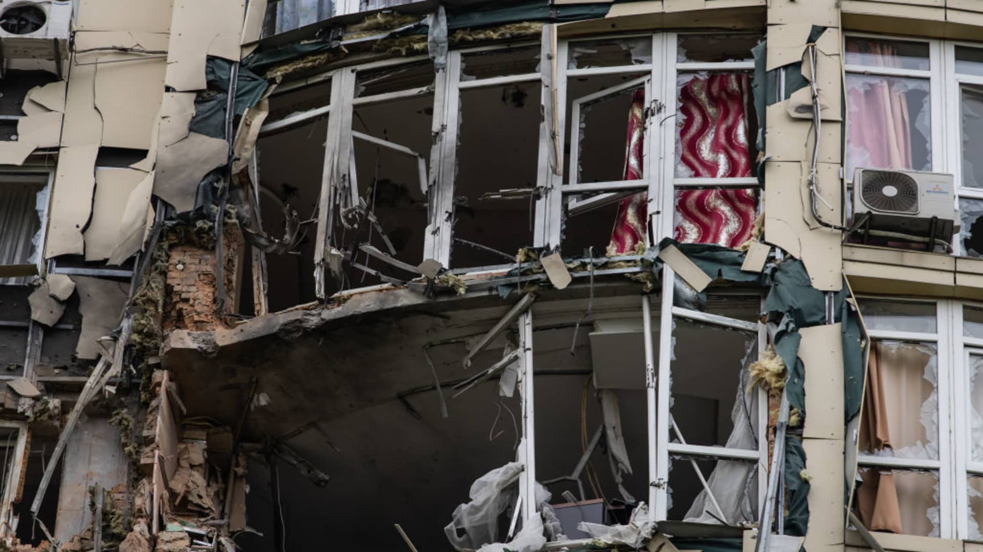 Damaged facade and windows of a residential building are seen as a result of a drone attack on May 8, 2023 in Kyiv, Ukraine. According to reports, Kyiv was attacked overnight by Russian drones. About 30 of them were destroyed with debris damaging a residential building and cars parked nearby.