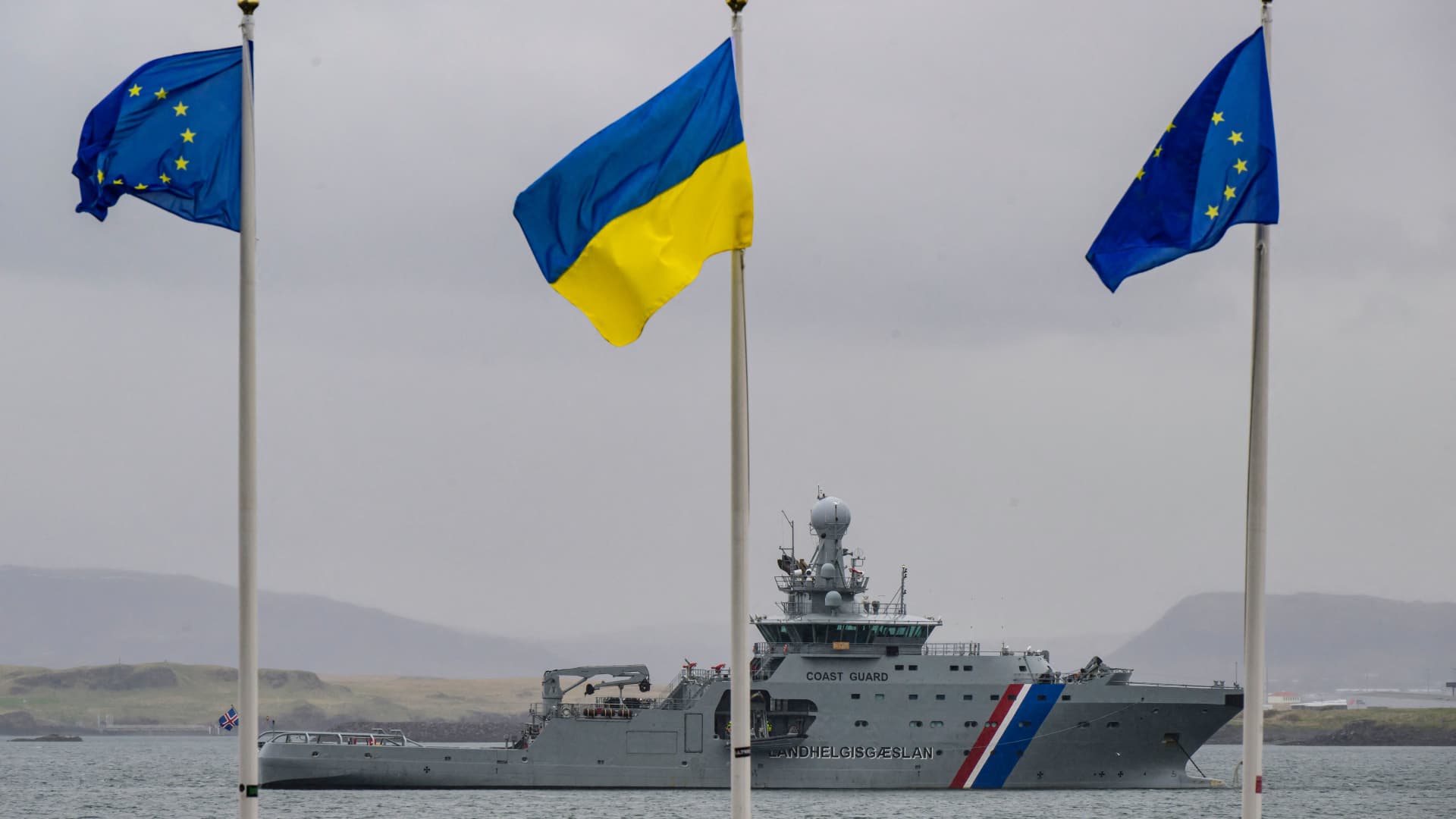 An Icelandic coast guard ship sails in front of EU and Ukraine flags flying in front of the Harpa Concert hall on May 16, 2023 in Reykjavik, Iceland, the venue of the 4th Summit of the Heads of State and Government of the Council of Europe, on the eve of the two-day summit.