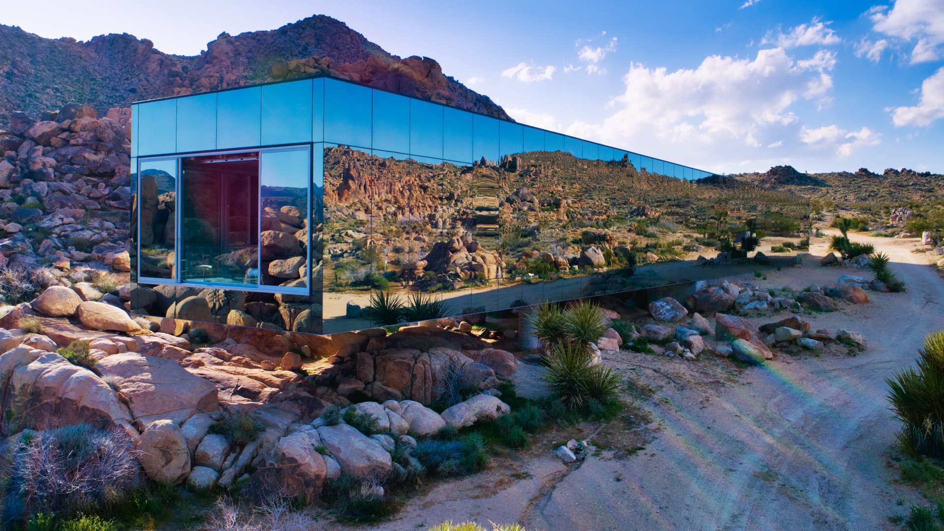 The Invisible House's mirror-clad facade creates the illusion of the home disappearing into the desert landscape.