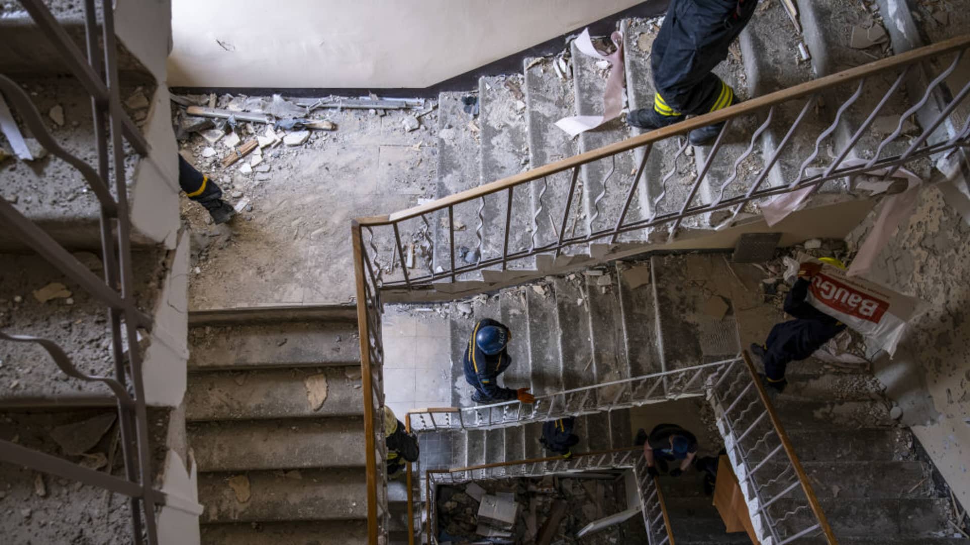 State workers observe the damage at a building that housed a fire station and a laboratory that was struck overnight in a round of fresh strikes in Dnipro city of Dnipropetrovsk Oblast, Ukraine on May 22, 2023.