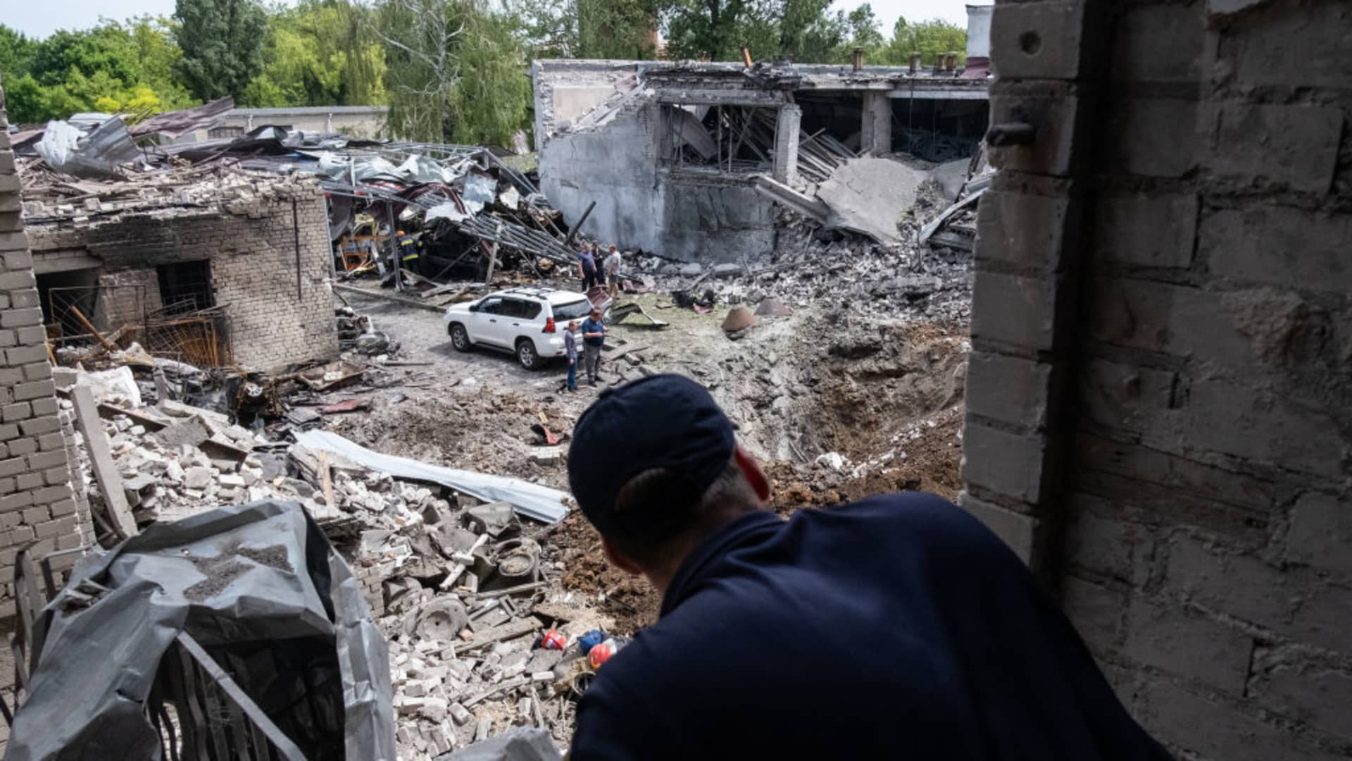 A Ukrainian firefighter observes the damage left behind by a missile strike at a building that housed a fire station and a laboratory that was struck overnight in a round of fresh strikes in Dnipro city of Dnipropetrovsk Oblast, Ukraine on May 22, 2023. 