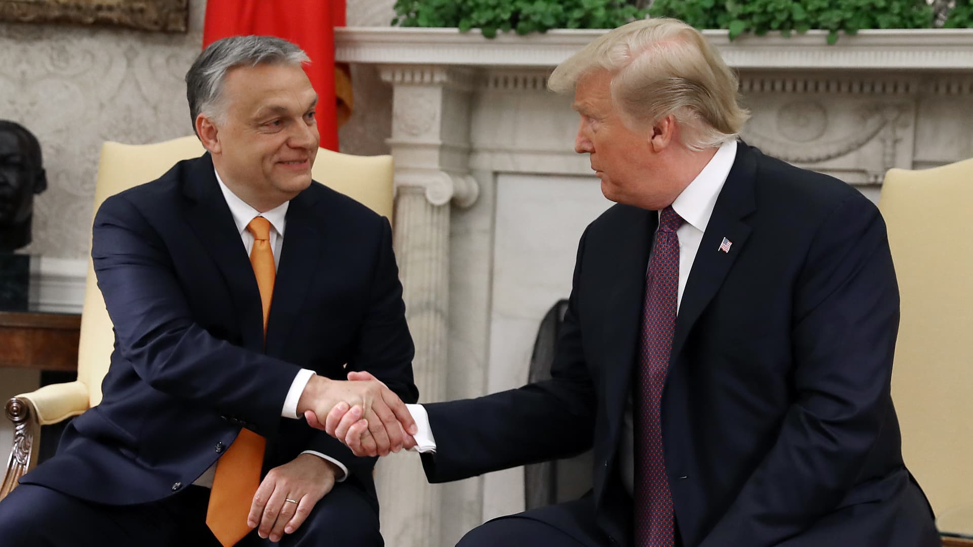 Former US President Donald Trump shakes hands with Hungarian Prime Minister Viktor Orban.