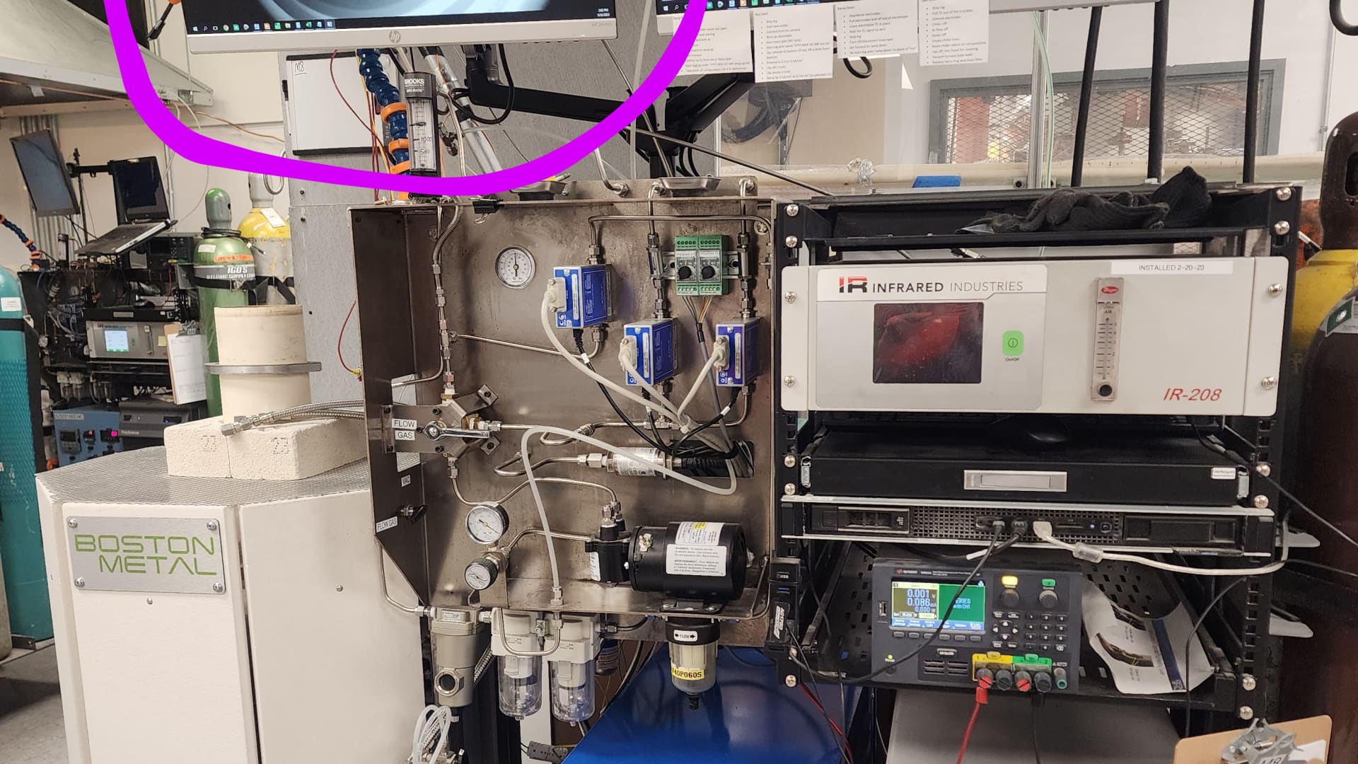 The Boston Metal electrolysis process releases oxygen as a byproduct. On the screen circled, oxygen bubbles can be seen being released.(The text on the white board has been blurred out to protect the intellectual property of Boston Metal.)