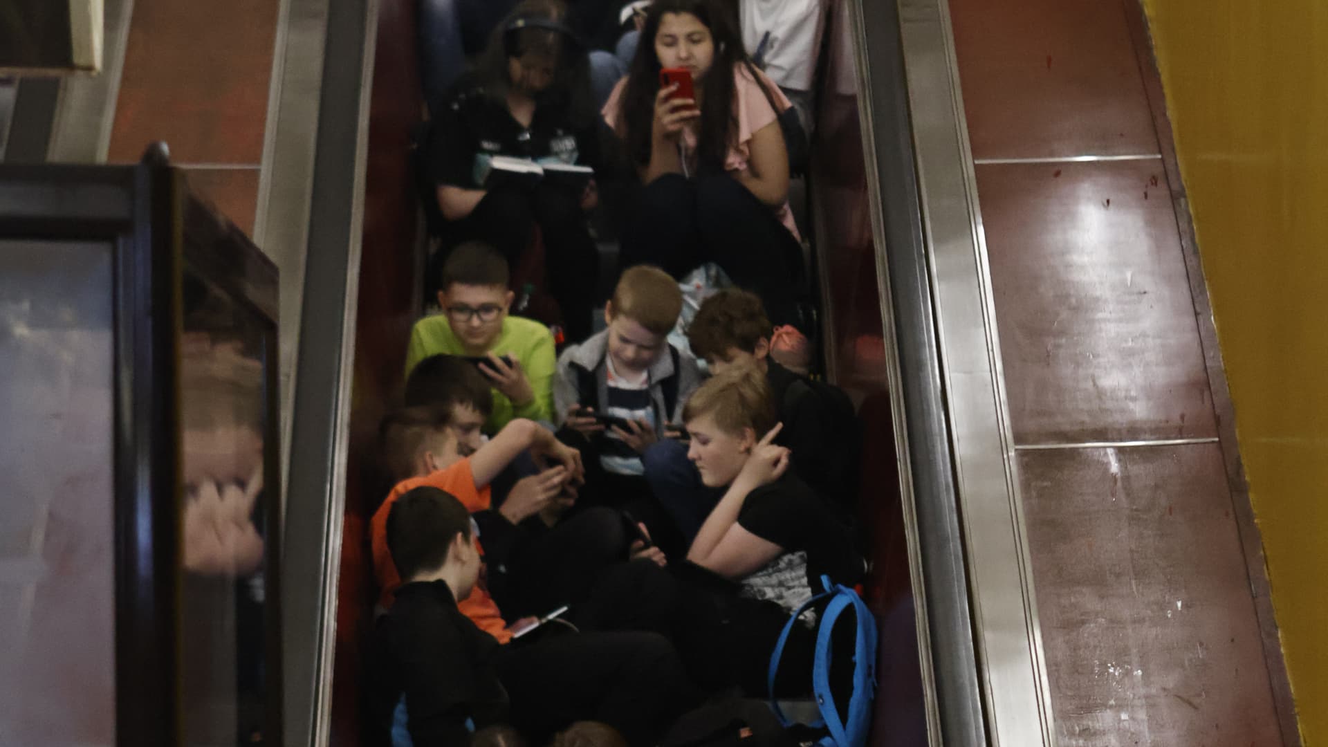 Children sit on the stairs of immobilized escalator in a metro station during an air alert on May 29, 2023 in Kyiv, Ukraine. During the day, Russian troops launched 11 ballistic missiles from the northern direction, which were managed to be destroyed by the means of Ukrainian air defense.