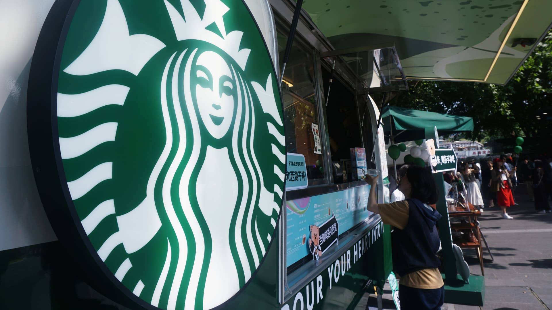 Shares producing the most significant moves midday: SBUX, KMX, SPCE