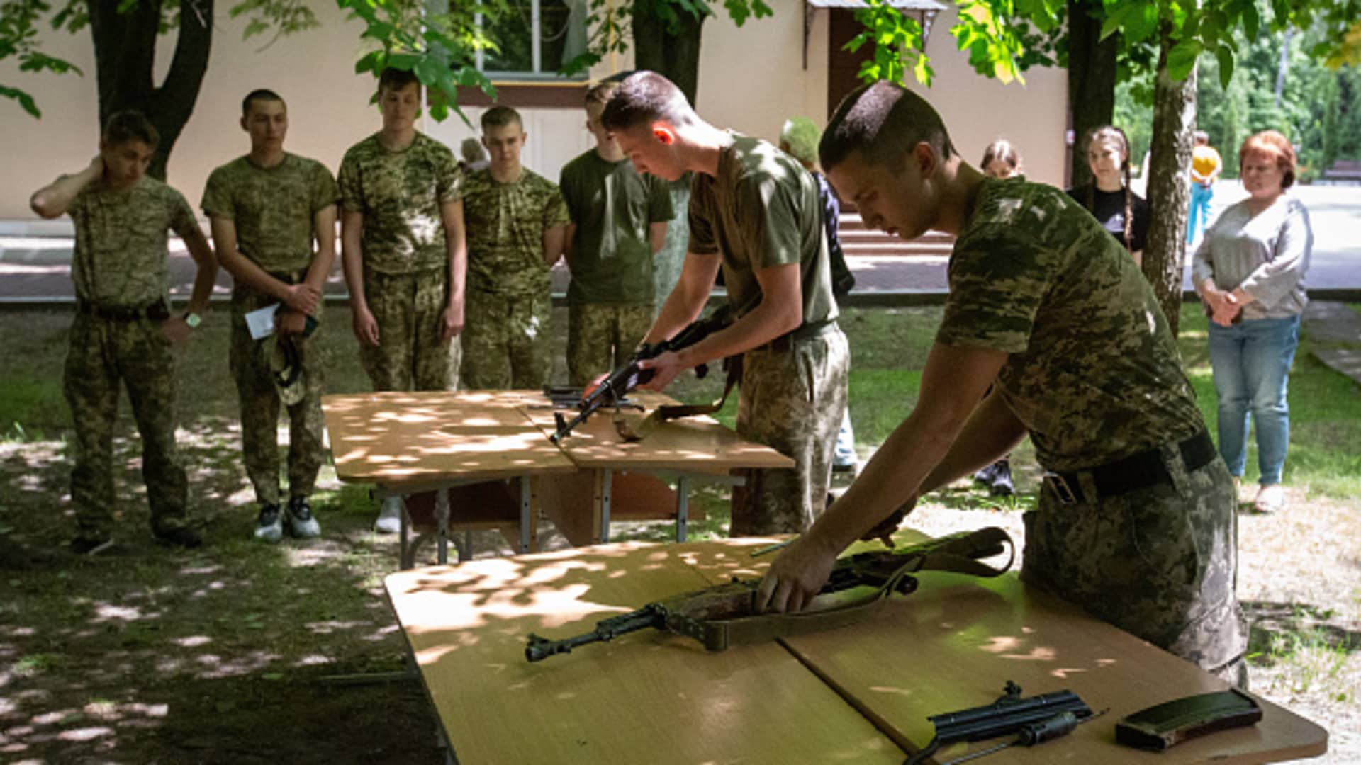 Young military cadets take part in an event with Kalashnikov assault rifles during a military competition at the cadet lyceum in Kyiv, Ukraine, on June 6, 2023.