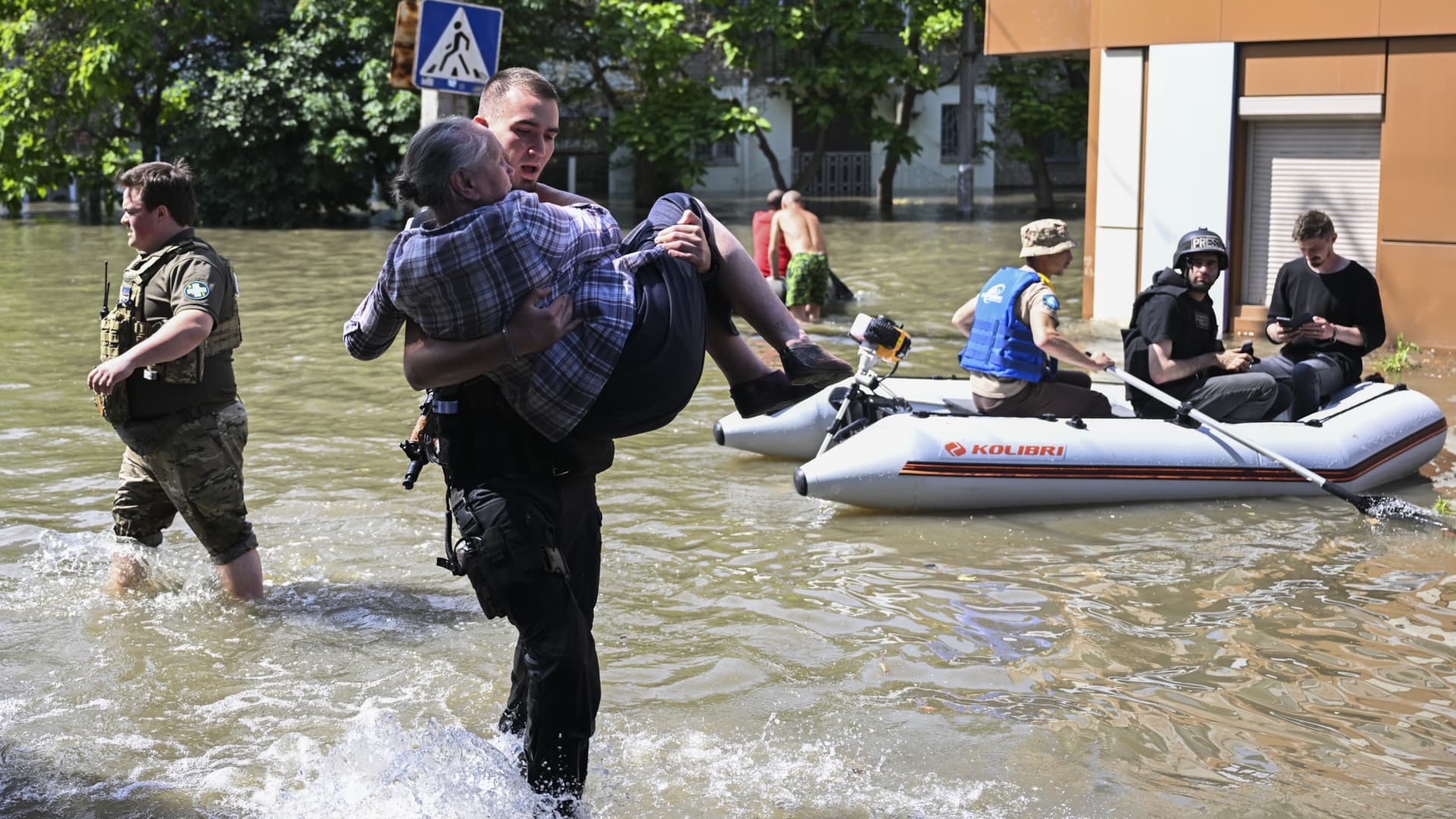 Officials help people to evacuate their homes after the explosion at the Kakhovka hydropower plant flooded the houses and streets in Kherson, Ukraine on June 7, 2023. 