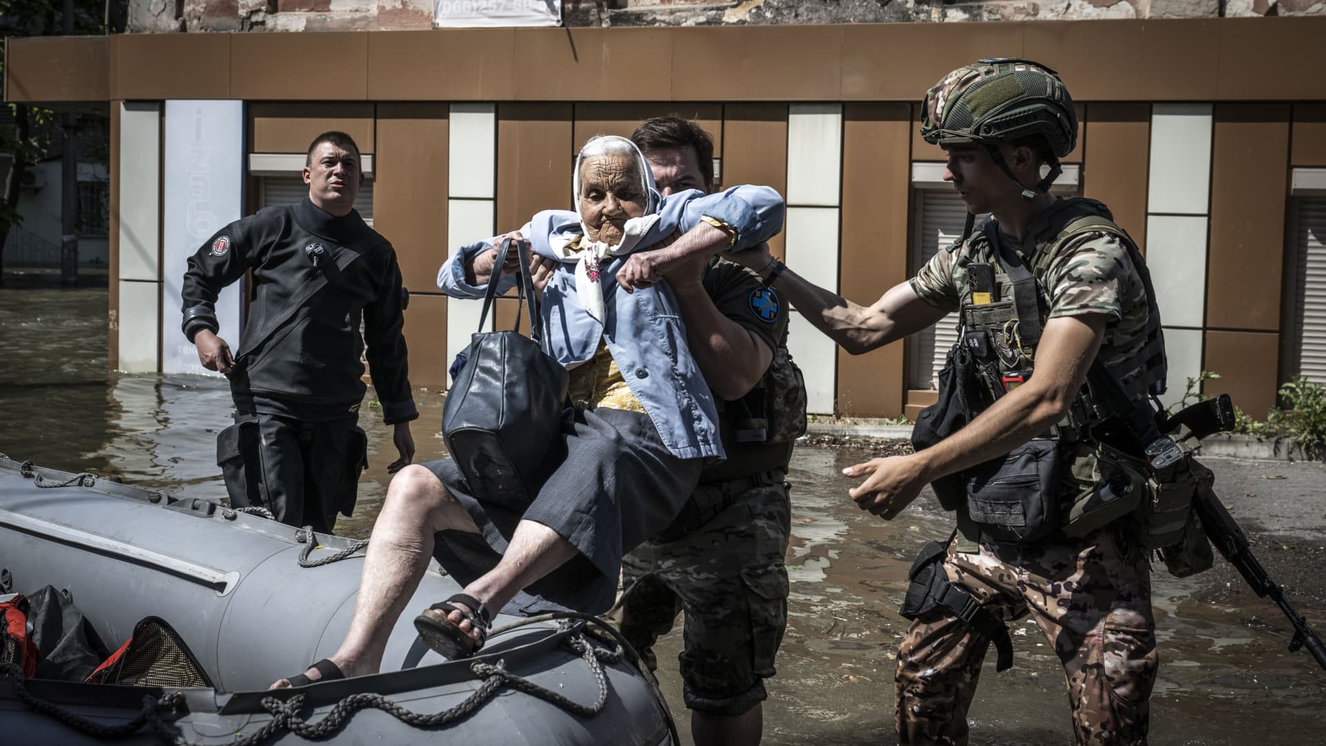 A Ukrainian senior woman is being evacuated by officers after the explosion at the Kakhovka hydropower plant that flooded houses and streets in Kherson, Ukraine on June 07, 2023. 
