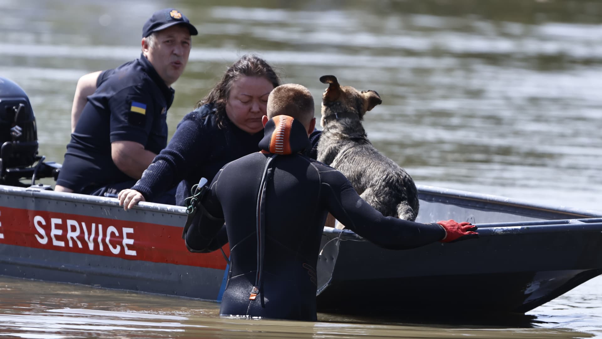 Rescuers evacuate a woman with her dog in the flooded area of the city of Kherson, Ukraine.