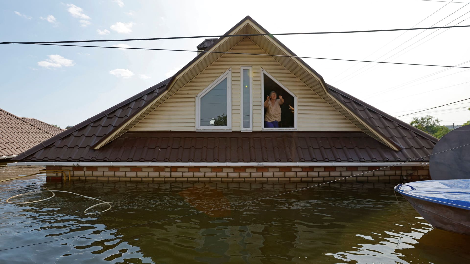  SENSITIVE MATERIAL. THIS IMAGE MAY OFFEND OR DISTURBA woman who refuses to be evacuated from a flooded house gestures towards the rescuers following the collapse of the Nova Kakhovka dam in the course of Russia-Ukraine conflict, in the town of Hola Prystan in the Kherson region, Russian-controlled Ukraine, June 8, 2023. 