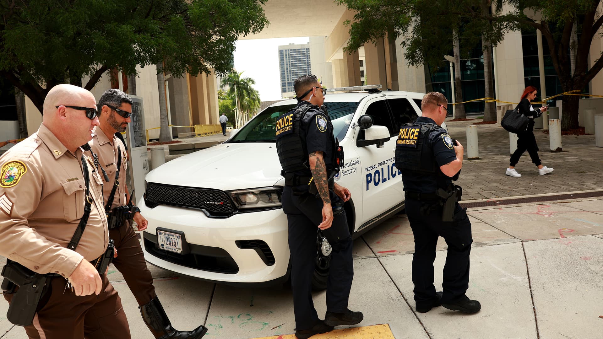 Department of Homeland Security police and Miami-Dade police walk in front of the Wilkie D. Ferguson Jr. United States Federal Courthouse where former President Donald Trump is scheduled to appear on June 12, 2023 in Miami, Florida.
