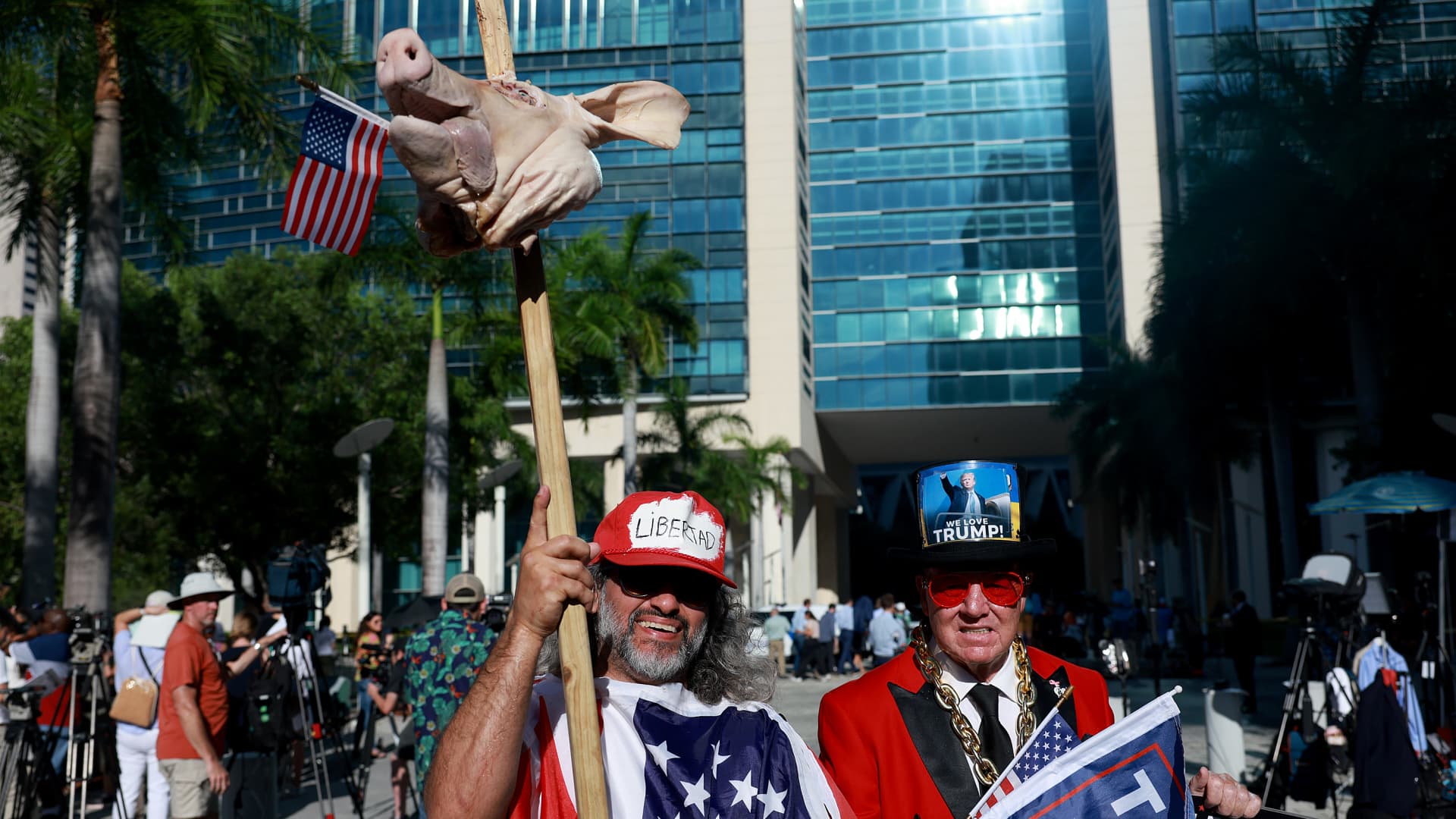 Osmany Estrada (L) holds a pigs head as he and Gregg Donovan gather outside the Wilkie D. Ferguson Jr. United States Federal Courthouse before the arraignment of former President Donald Trump on June 13, 2023 in Miami, Florida.