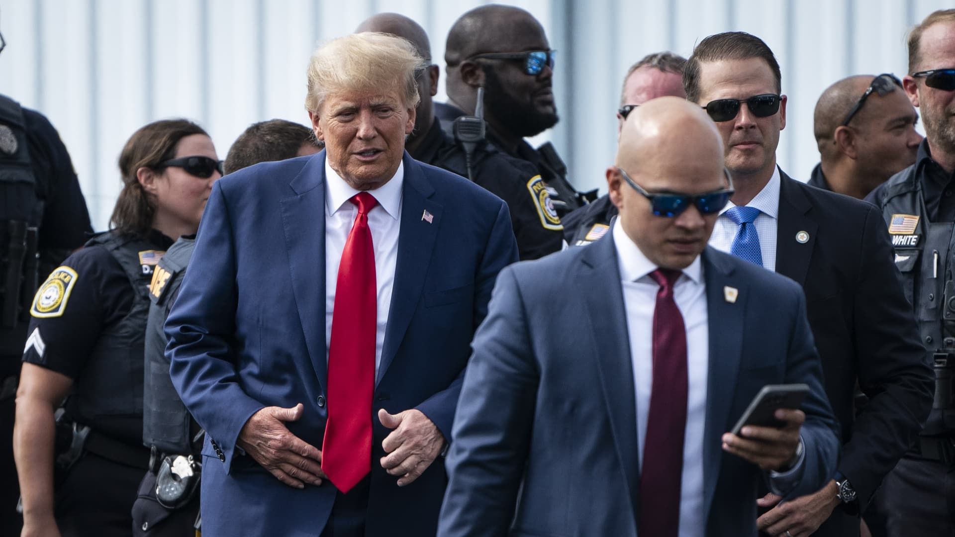 Former President Donald Trump and his aid Walt Nauta (right) arrive at an airport after Trump spoke at the Georgia Republican Party's state convention on Saturday, June 10, 2023 in Columbus, GA. 