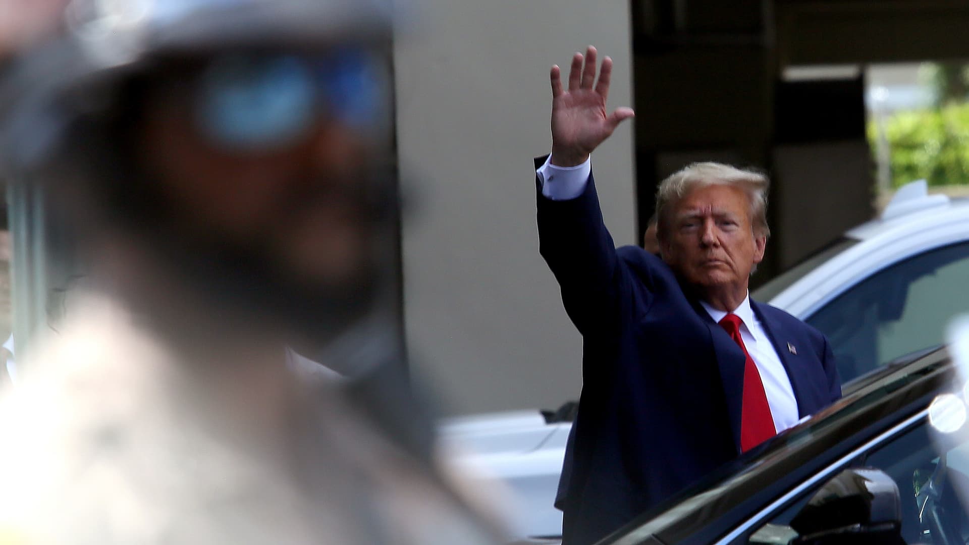 Former U.S. President Donald Trump waves as he makes a visit to the Cuban restaurant Versailles after he appeared for his arraignment on June 13, 2023 in Miami, Florida.