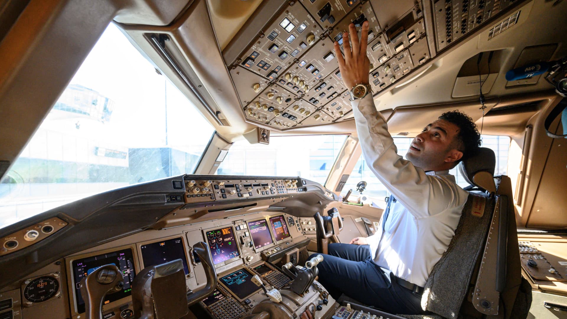 Pilot Omar Morsi checks controls in the cockpit of a United Airlines Boeing 777 aircraft at Newark Liberty International Airport in Newark, New Jersey, on March 9, 2023.