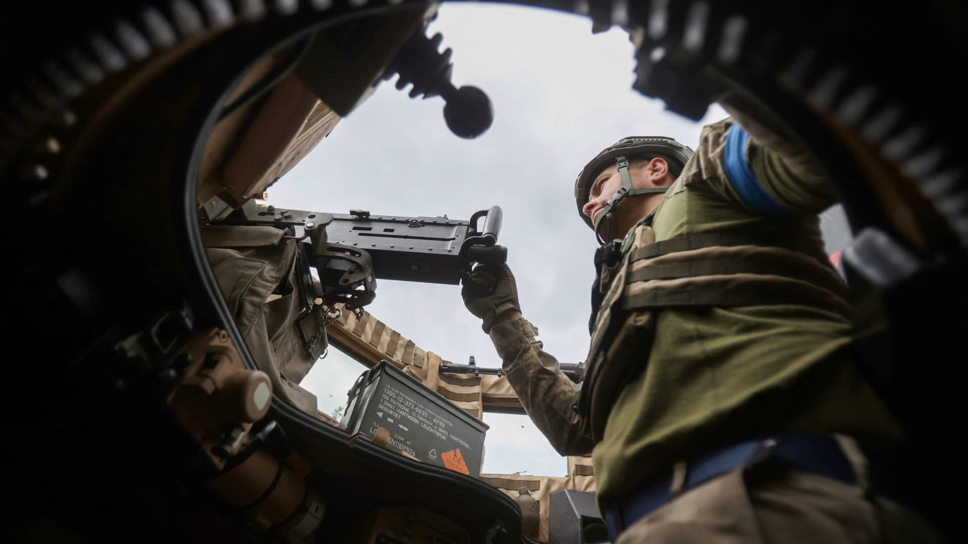 A Ukrainian serviceman mans a machine gun as he rides on a MaxxPro MRAP in the recently liberated village of Blagodatne, Donetsk region on June 16, 2023, amid the Russian invasion of Ukraine. 
