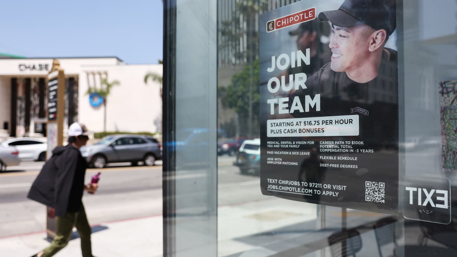 A 'Join Our Team' sign is displayed outside a Chipotle location, listing employee benefits, on June 2, 2023 in Los Angeles, California.