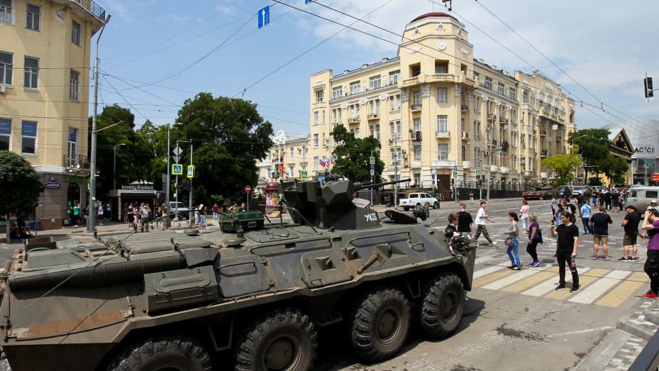 People walk past an armoured personnel carrier in the city of Rostov-on-Don, on June 24, 2023.