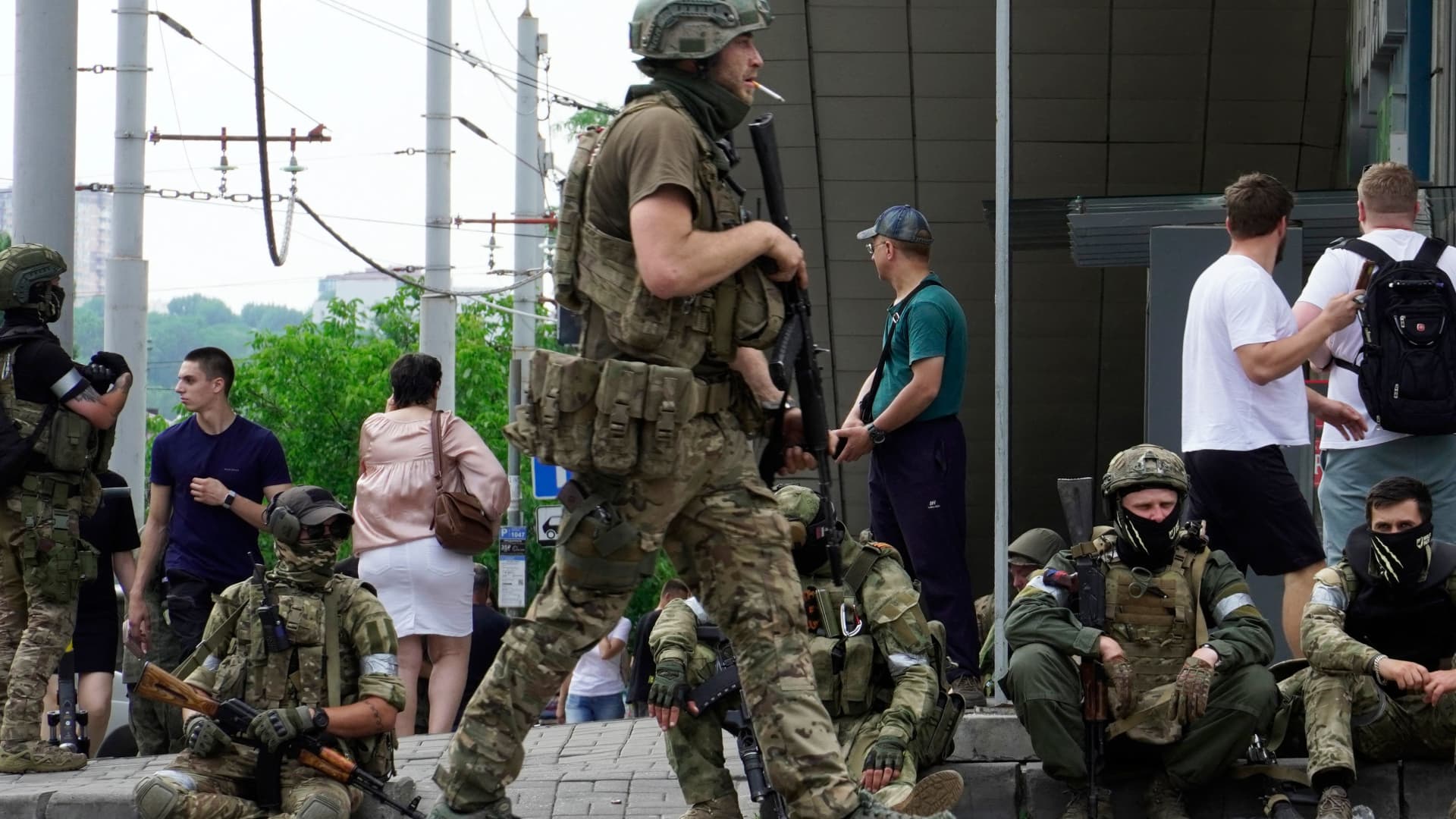 Members of Wagner group sit on the sidewalk as they patrol the center of Rostov-on-Don, on June 24, 2023. 