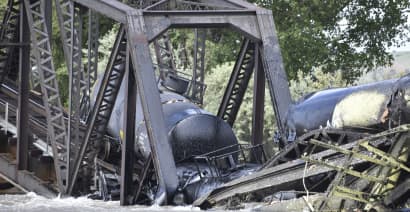 Train carrying hazardous materials derails and bridge collapses into Montana river