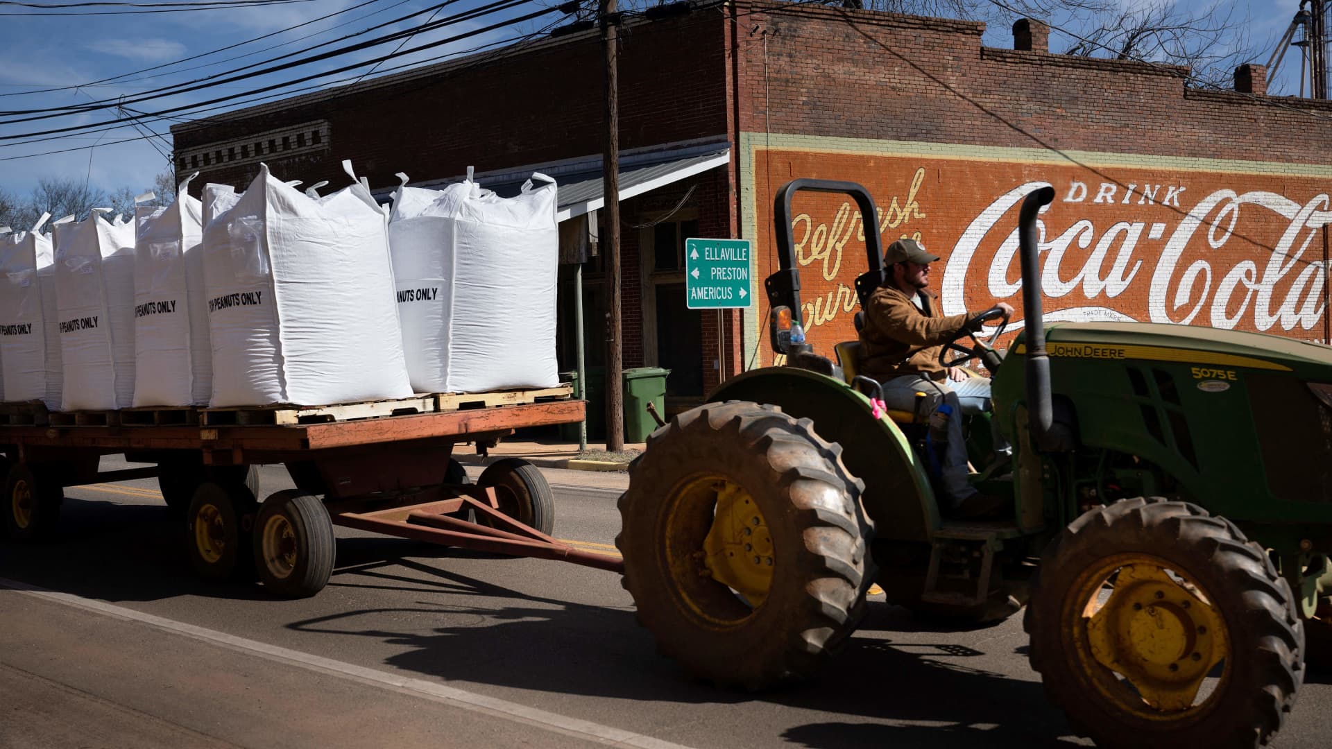 A worker transports peanuts used for seeds from a shelling facility in Plains, Georgia, on February 20, 2023.