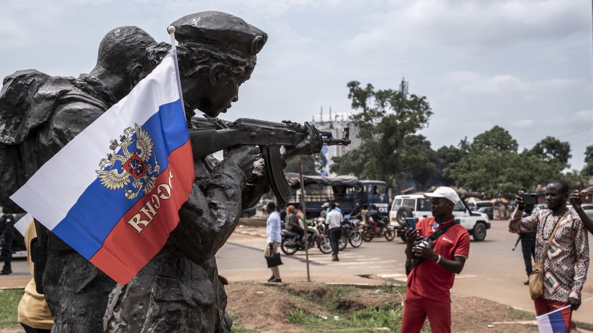 BANGUI, Central African Republic - March 22, 2023: A Russian flag hangs on the monument of the Russian instructors in Bangui, during a march in support of Russia and China's presence in the Central African Republic. Wagner Group has been active in the country since 2018, supporting President Faustin-Archange Touadéra's government and filling a security vacuum left by France.