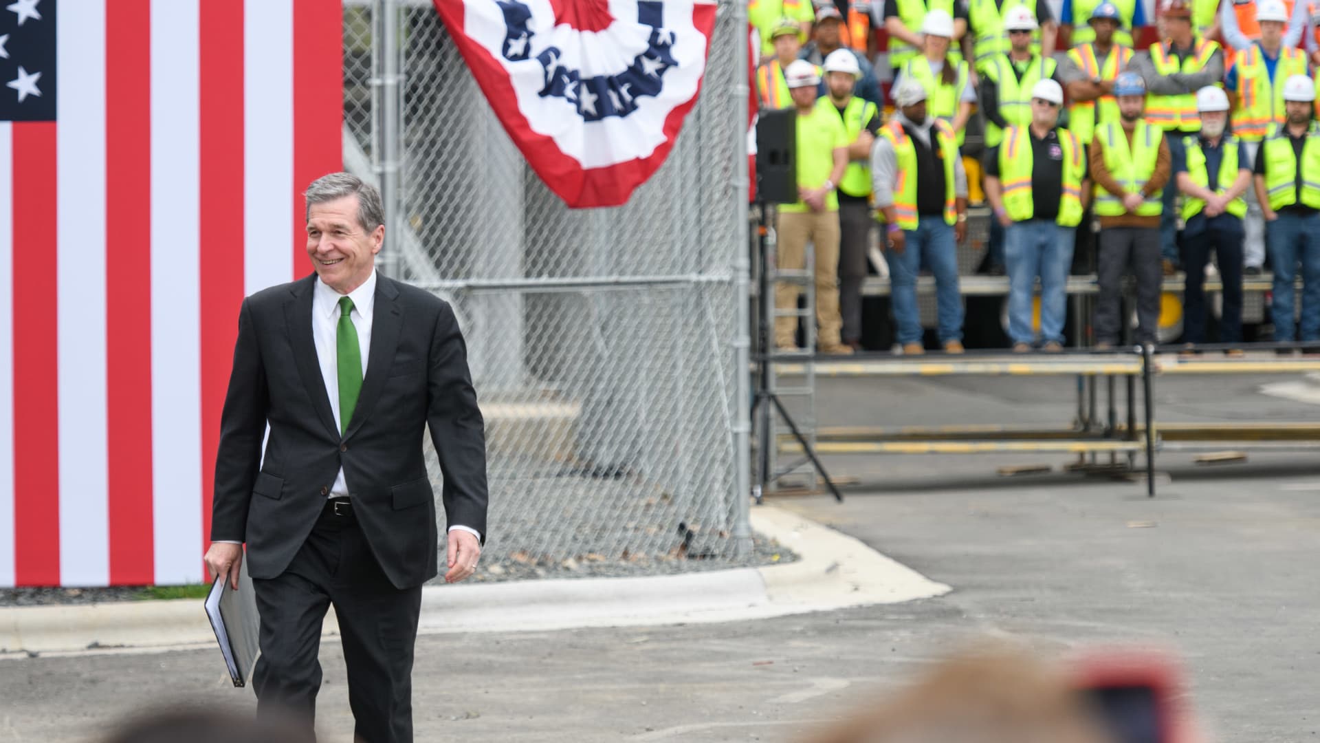 North Carolina Gov. Roy Cooper walks to the podium to address the crowd during President Joe Biden's visit to Wolfspeed, a semiconductor manufacturer, in Durham, North Carolina, March 28, 2023.