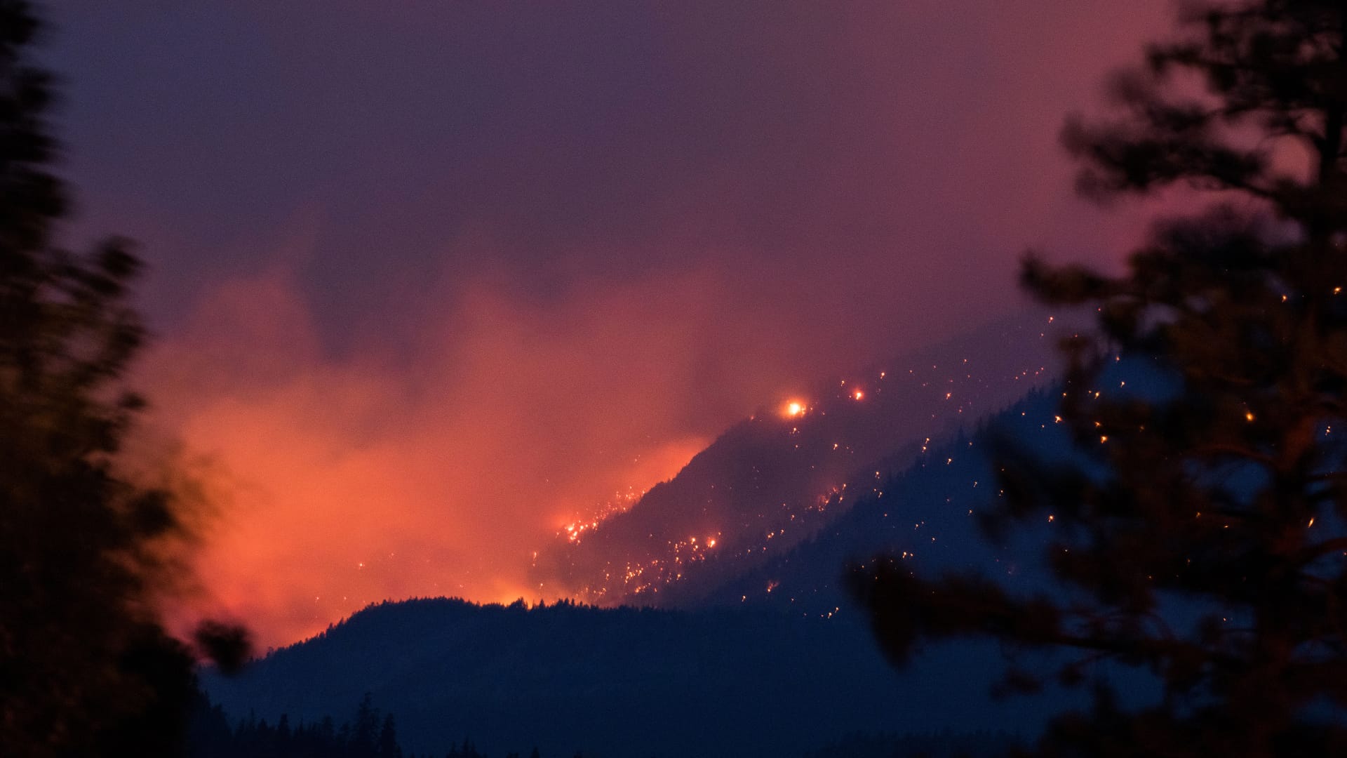 Wildfire burns above the Fraser River Valley near Lytton, British Columbia, Canada, on Friday, July 2, 2021. A protracted heat wave continues to fuel scores of wildfires in Canada's western provinces, with Prime Minister Justin Trudeau calling an emergency meeting of a cabinet crisis group to address the matter.